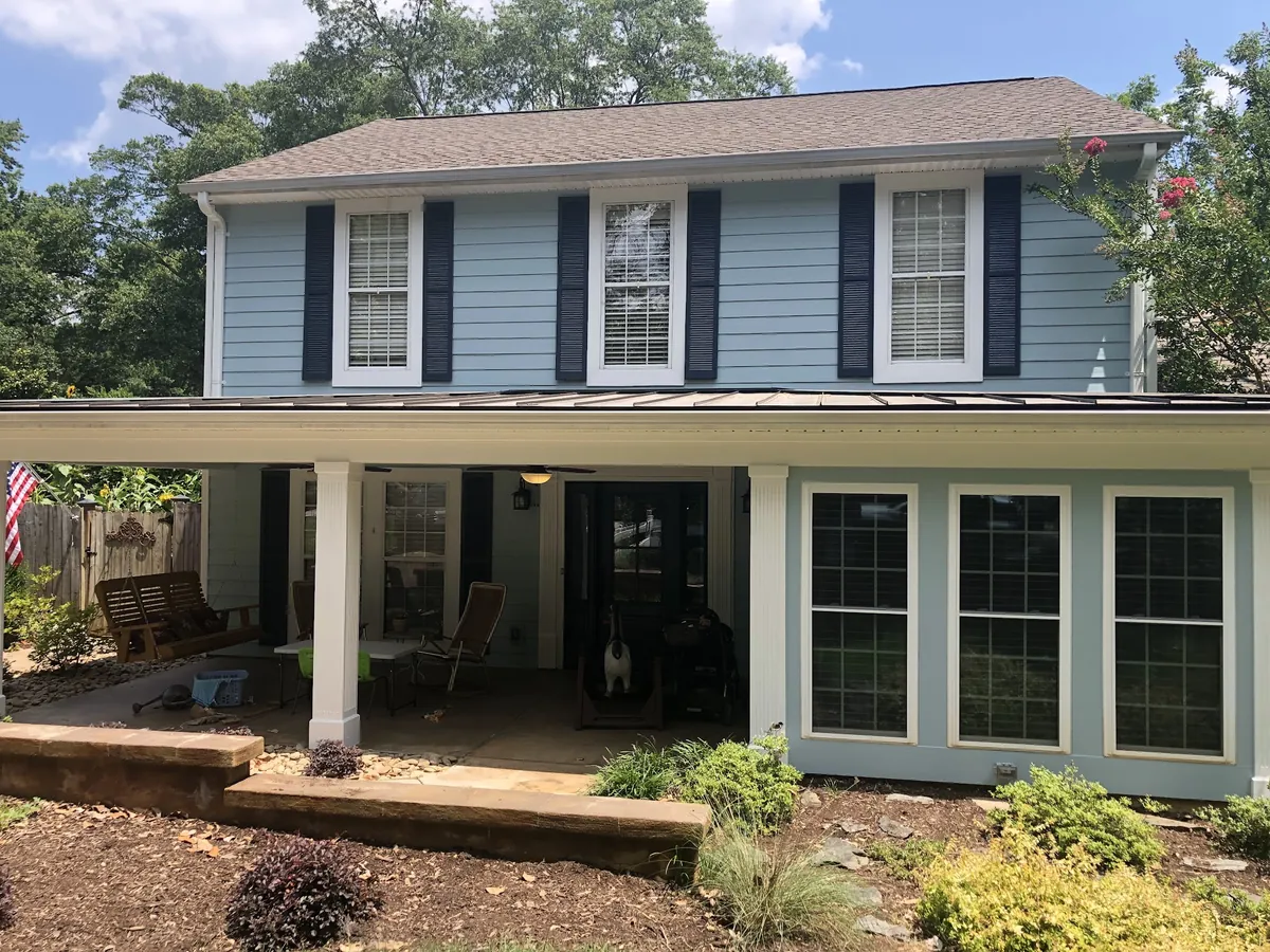 Two-story colonial with blue siding, white trim and a covered porch