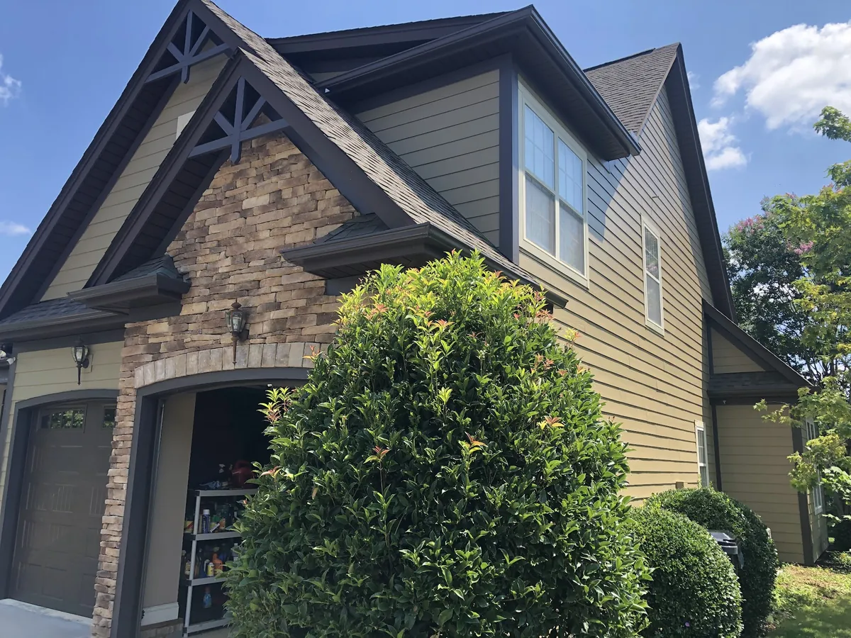 Craftsman home with stone accents and dark painted trim