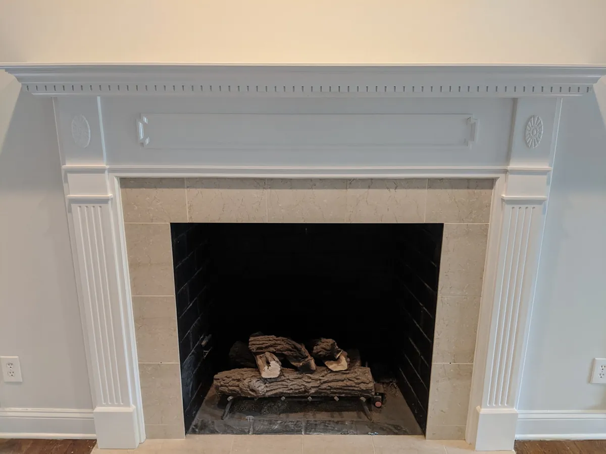 Fireplace with a freshly painted white mantel and surround