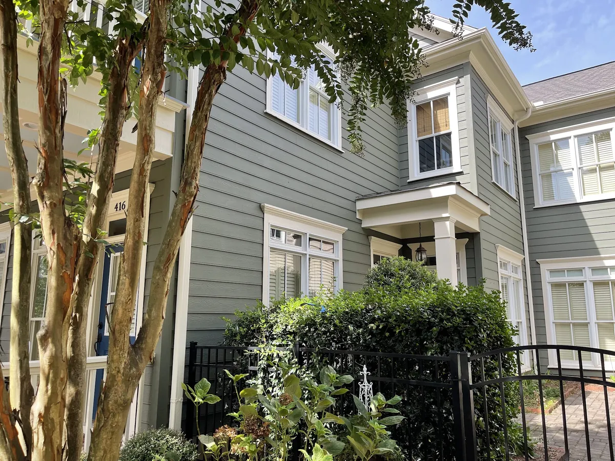 Two-story home with sage green siding and white trim