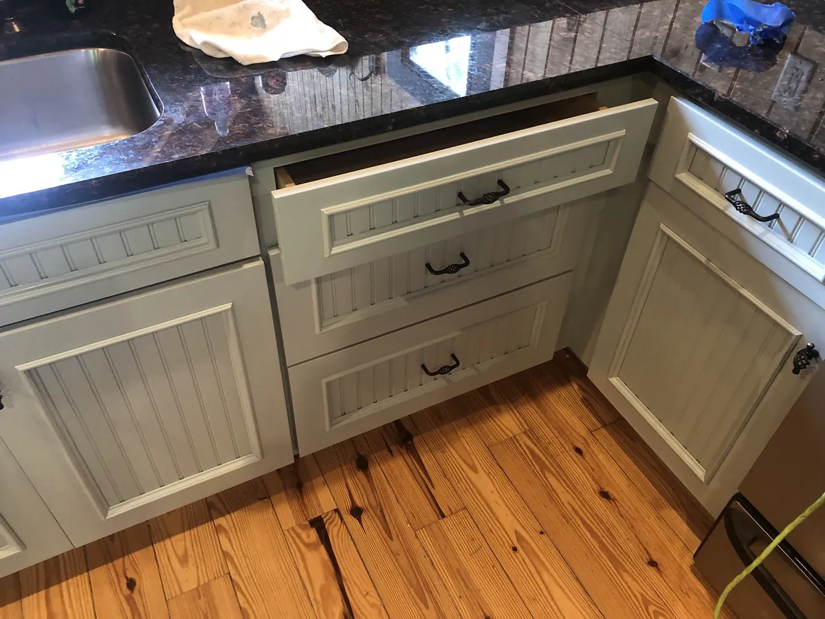 Kitchen cabinets freshly painted in a soft white