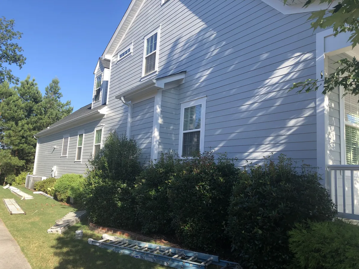 Two-story home with light blue siding and white trim