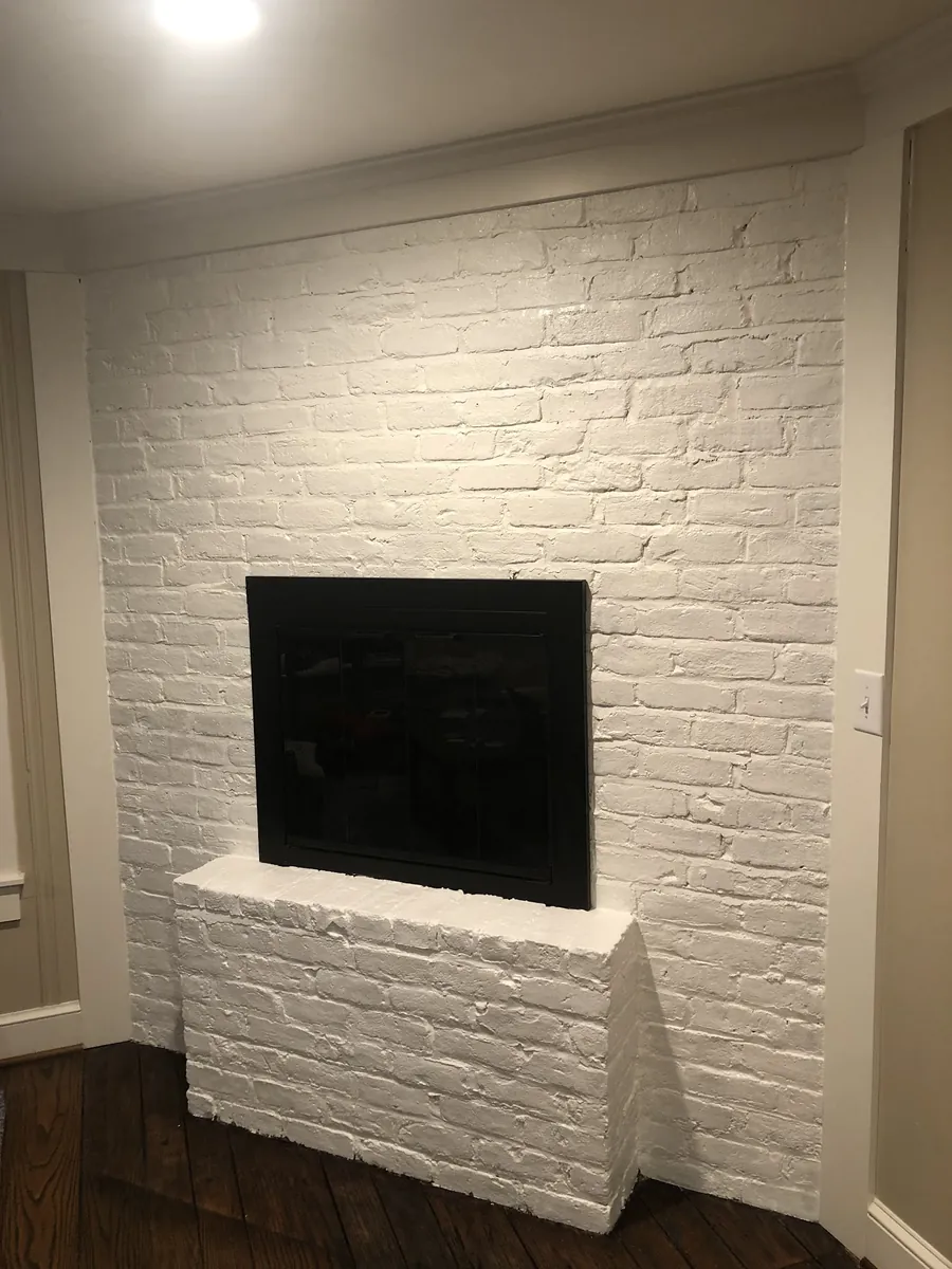 Brick fireplace wall painted white