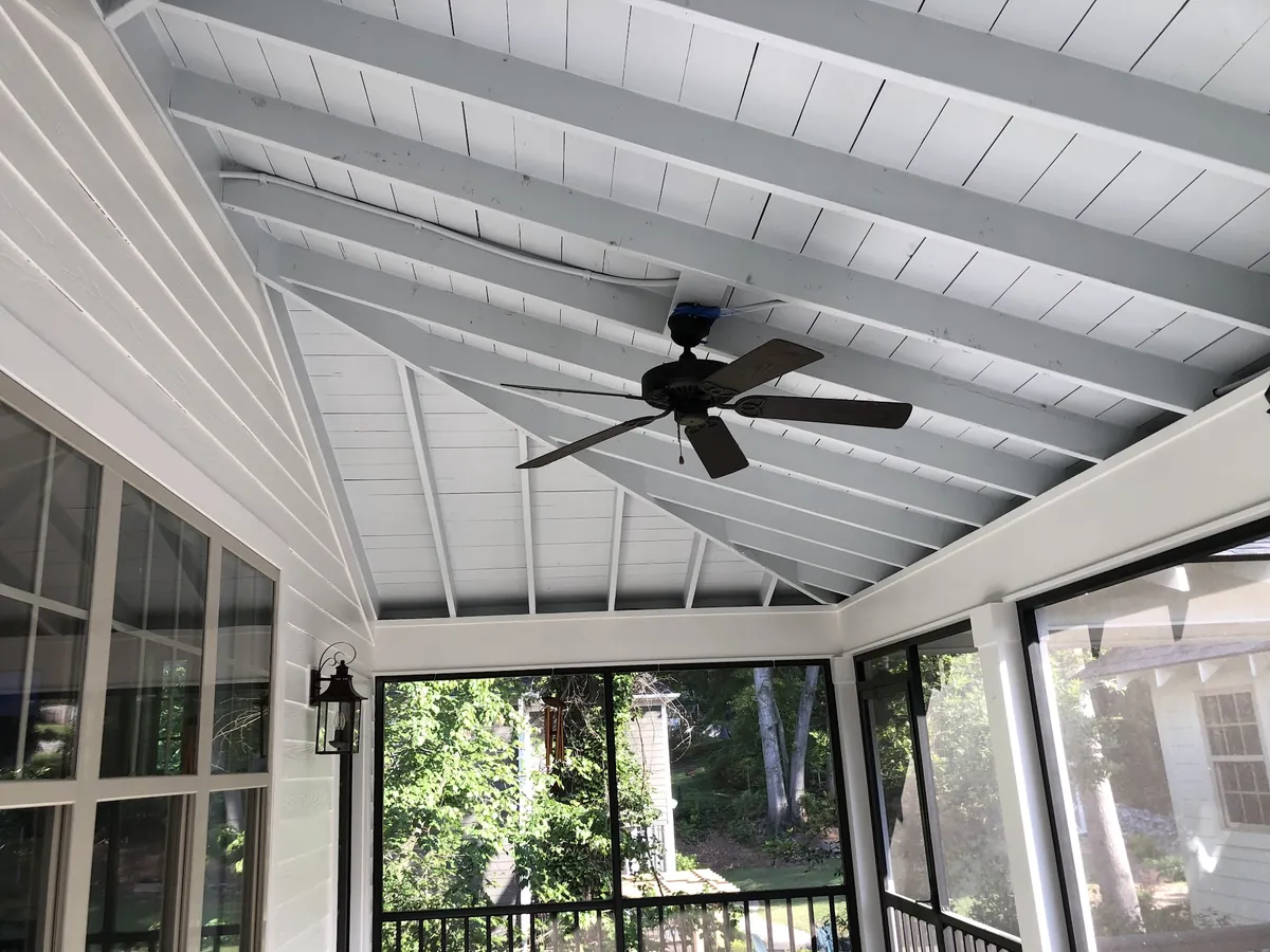 Screened porch with a freshly painted white ceiling and trim