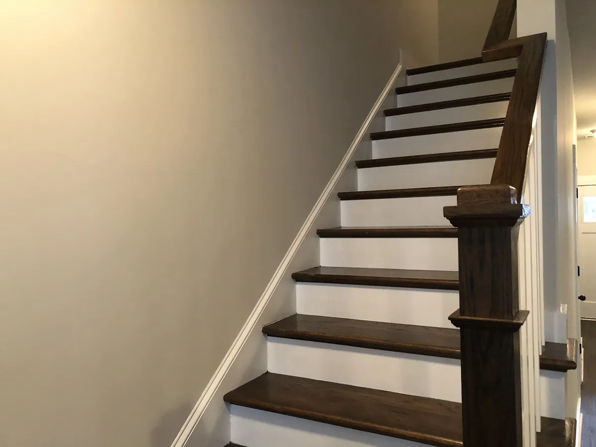 Staircase with white risers and painted trim