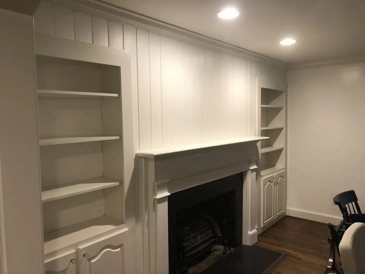 Fireplace wall with built-in shelves painted white