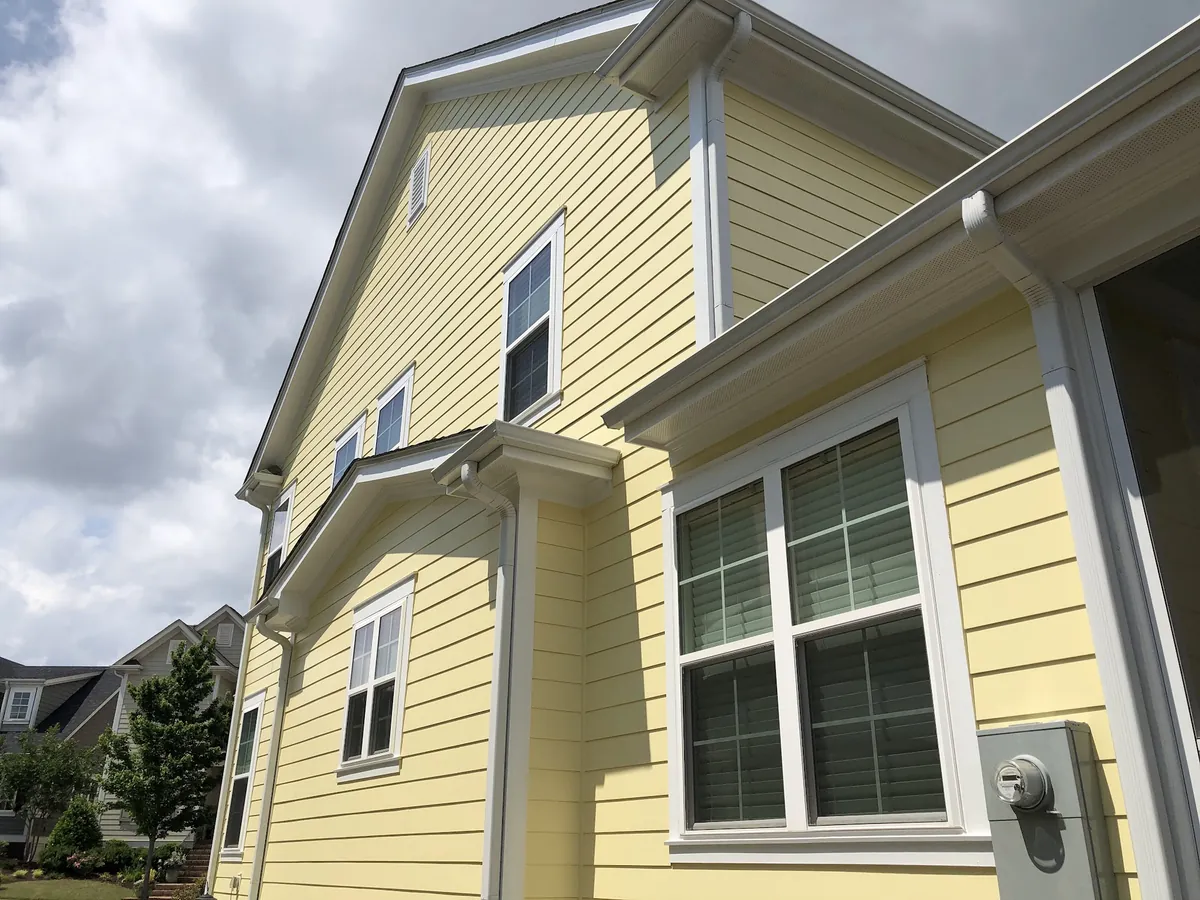 Yellow two-story home with crisp white trim